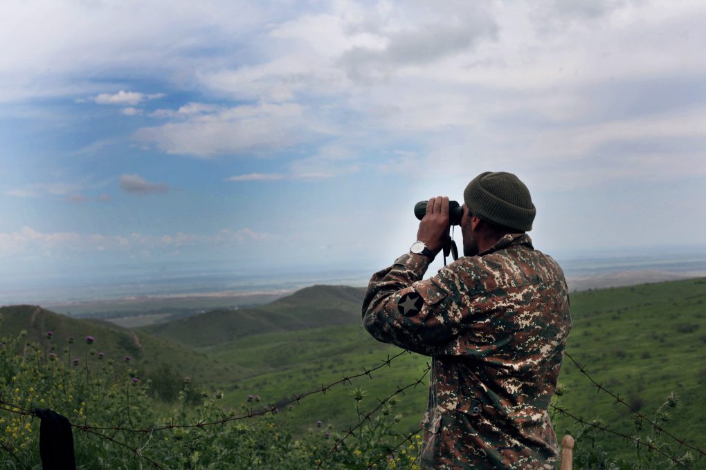 Armenian serviceman observing Azerbaijani positions. Image courtesy of CivilNet.